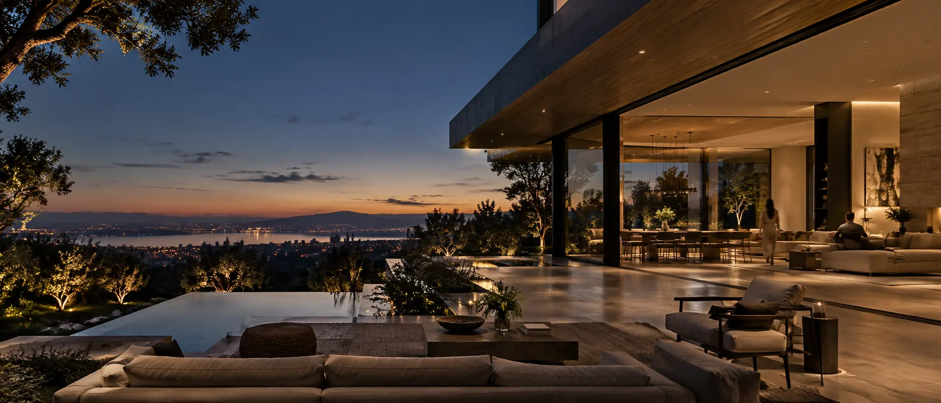 A connected residence extending seamlessly from its interior to the landscape at dusk.