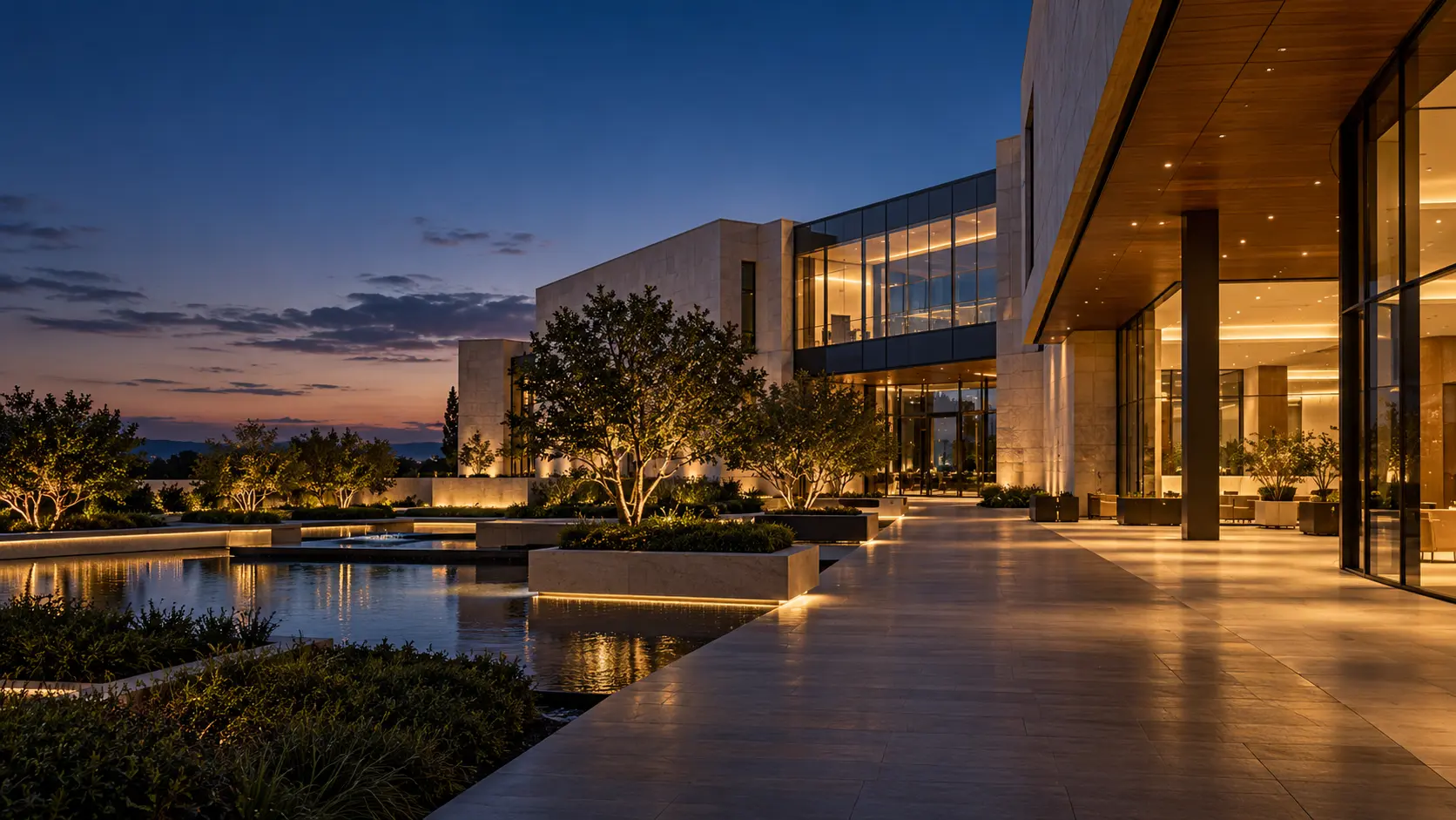 A tranquil modern workplace campus with well illuminated paths at dusk.